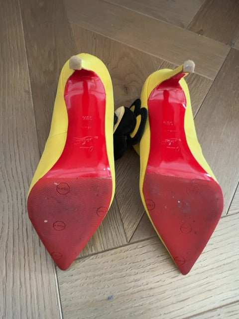 Louboutins Pensee pansy-flower embellishment Mary Jane pumps, featuring yellow satin and the brand's signature red sole