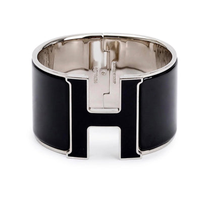 Hermès Clic Clac H bracelet featuring black enamel and palladium-plated hardware