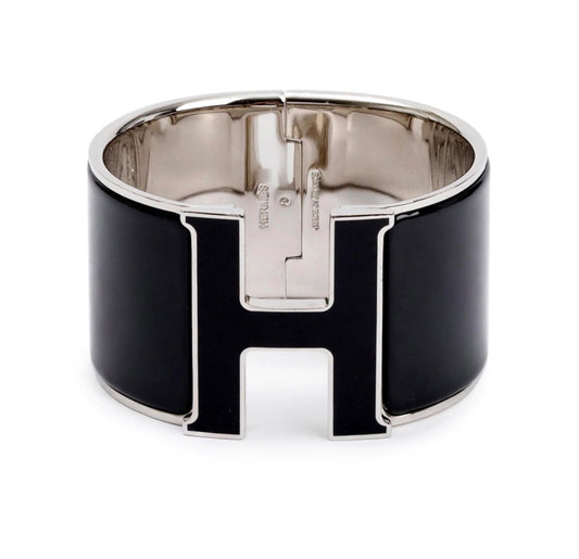 Hermès Clic Clac H bracelet featuring black enamel and palladium-plated hardware
