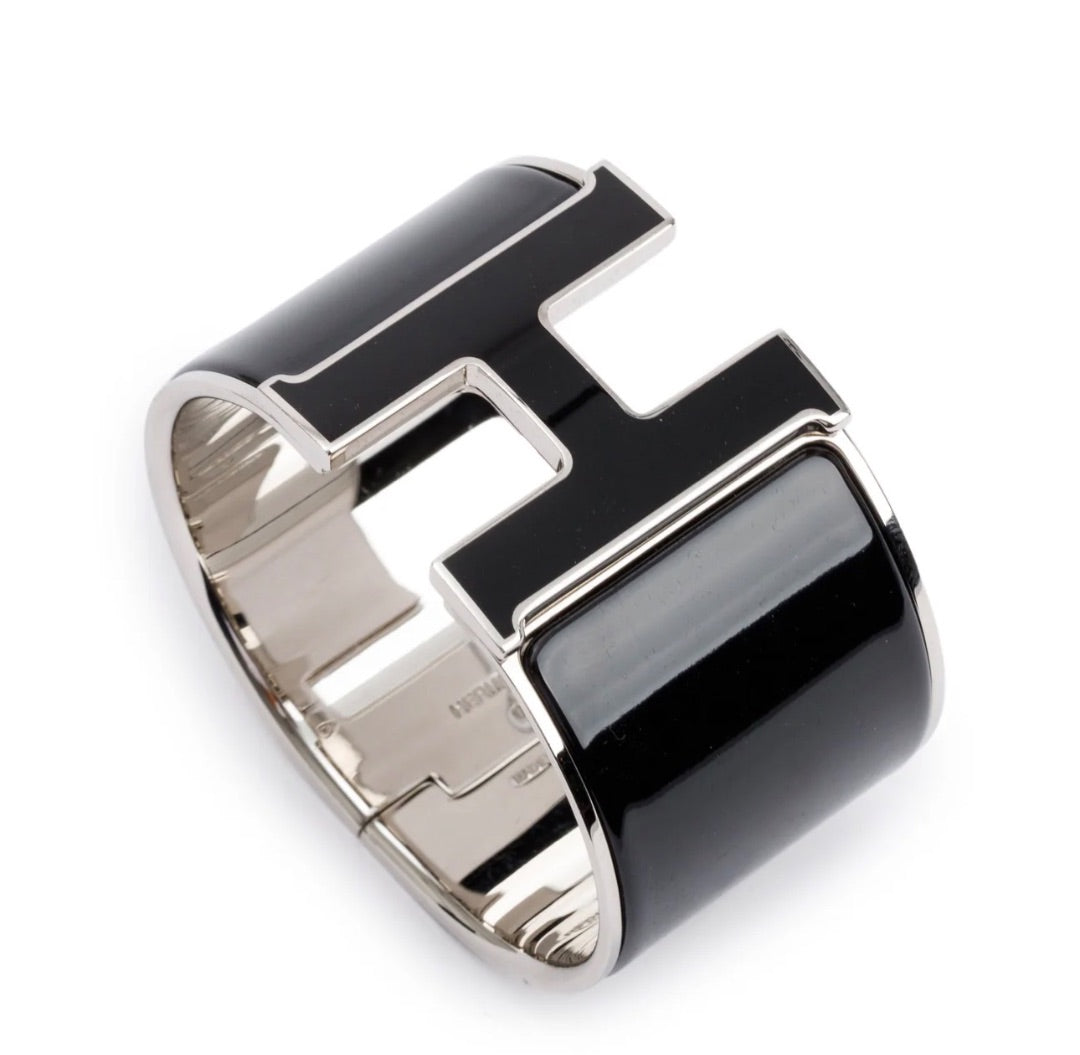 Hermès Clic Clac H bracelet featuring black enamel and palladium-plated hardware