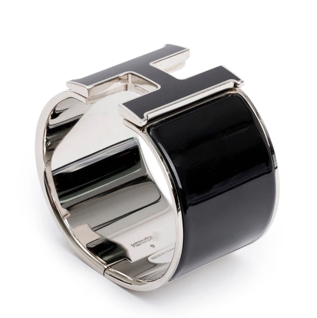 Hermès Clic Clac H bracelet featuring black enamel and palladium-plated hardware