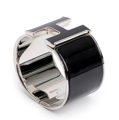 Hermès Clic Clac H bracelet featuring black enamel and palladium-plated hardware