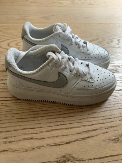 Nike Court Vision Alta sneakers in a white and metallic silver colorway