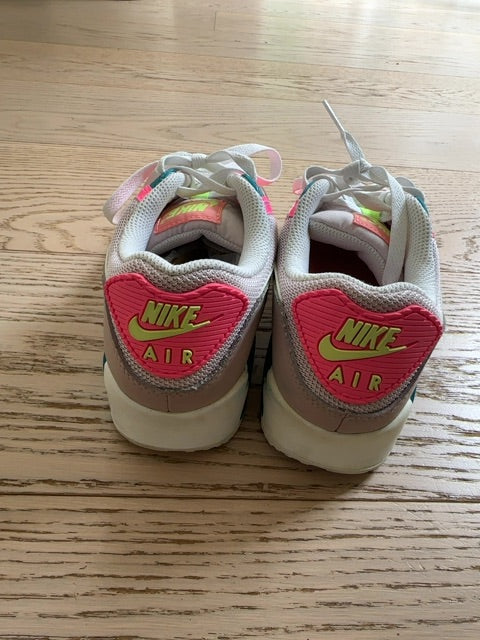 Nike Air Max 90 sneakers, specifically identified in a "Rose Ghost Green Volt" or neon "Exeter Edition" colorway
