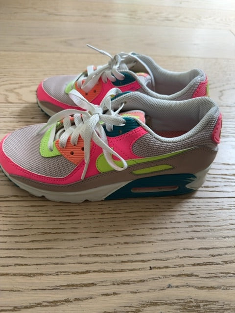 Nike Air Max 90 sneakers, specifically identified in a "Rose Ghost Green Volt" or neon "Exeter Edition" colorway