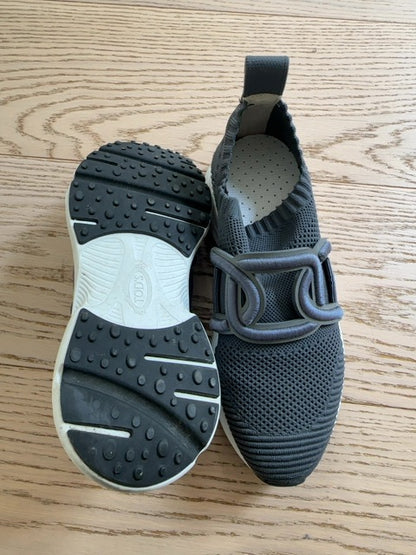 Tods Kate slip-on sneakers featuring a gray stretch-knit upper and a leather chain-style strap detail