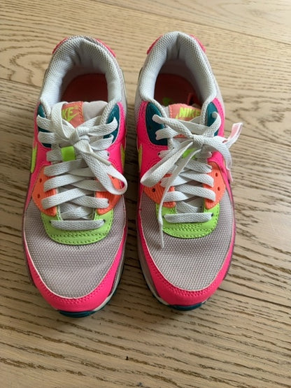 Nike Air Max 90 sneakers, specifically identified in a "Rose Ghost Green Volt" or neon "Exeter Edition" colorway