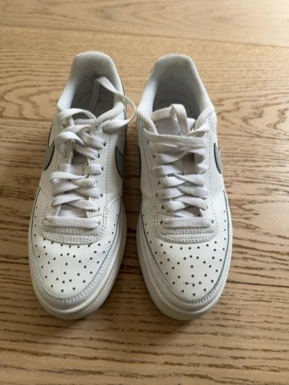 Nike Court Vision Alta sneakers in a white and metallic silver colorway