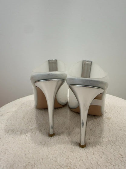 Gianvito Rossi Sigma mules feature a distinctive crystal-encrusted