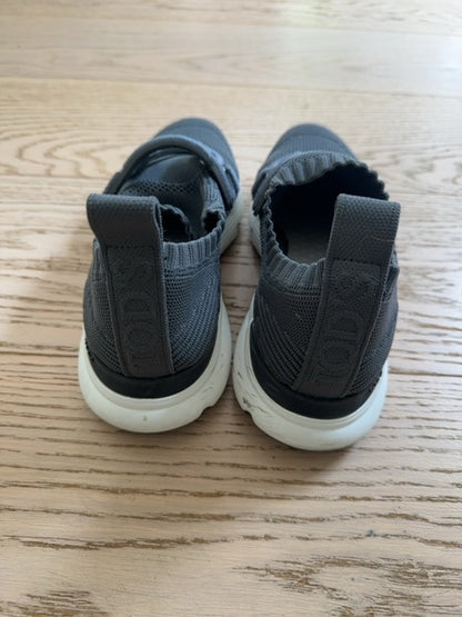 Tods Kate slip-on sneakers featuring a gray stretch-knit upper and a leather chain-style strap detail