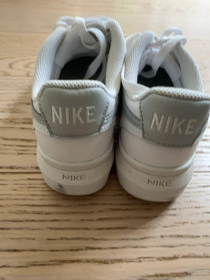 Nike Court Vision Alta sneakers in a white and metallic silver colorway