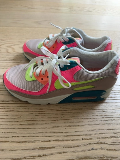Nike Air Max 90 sneakers, specifically identified in a "Rose Ghost Green Volt" or neon "Exeter Edition" colorway