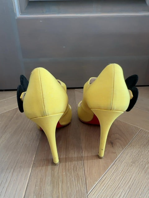 Louboutins Pensee pansy-flower embellishment Mary Jane pumps, featuring yellow satin and the brand's signature red sole