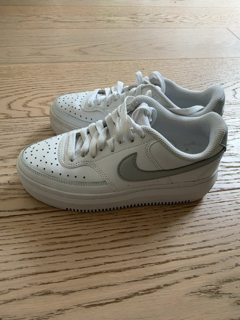 Nike Court Vision Alta sneakers in a white and metallic silver colorway