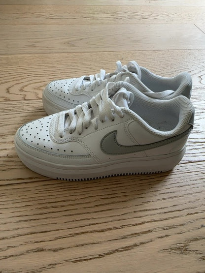 Nike Court Vision Alta sneakers in a white and metallic silver colorway