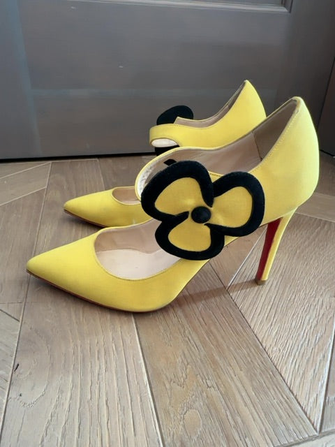 Louboutins Pensee pansy-flower embellishment Mary Jane pumps, featuring yellow satin and the brand's signature red sole