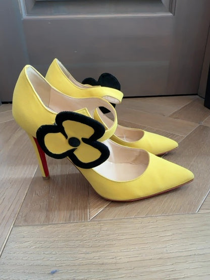 Louboutins Pensee pansy-flower embellishment Mary Jane pumps, featuring yellow satin and the brand's signature red sole