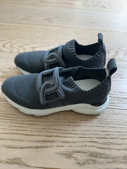 Tods Kate slip-on sneakers featuring a gray stretch-knit upper and a leather chain-style strap detail