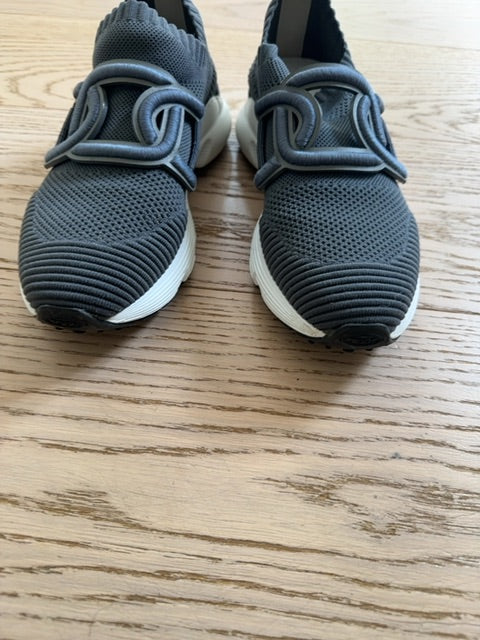 Tods Kate slip-on sneakers featuring a gray stretch-knit upper and a leather chain-style strap detail