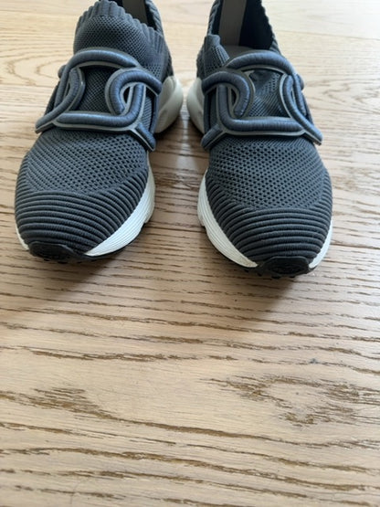 Tods Kate slip-on sneakers featuring a gray stretch-knit upper and a leather chain-style strap detail