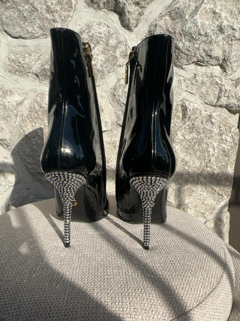 Dolce & Gabbana Patent leather ankle boots featuring crystal embellishments on the pointed toe and heel